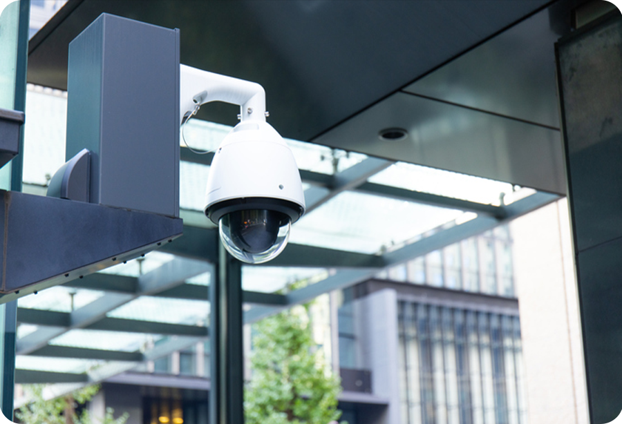commercial security camera hanging from ceiling in commercial building