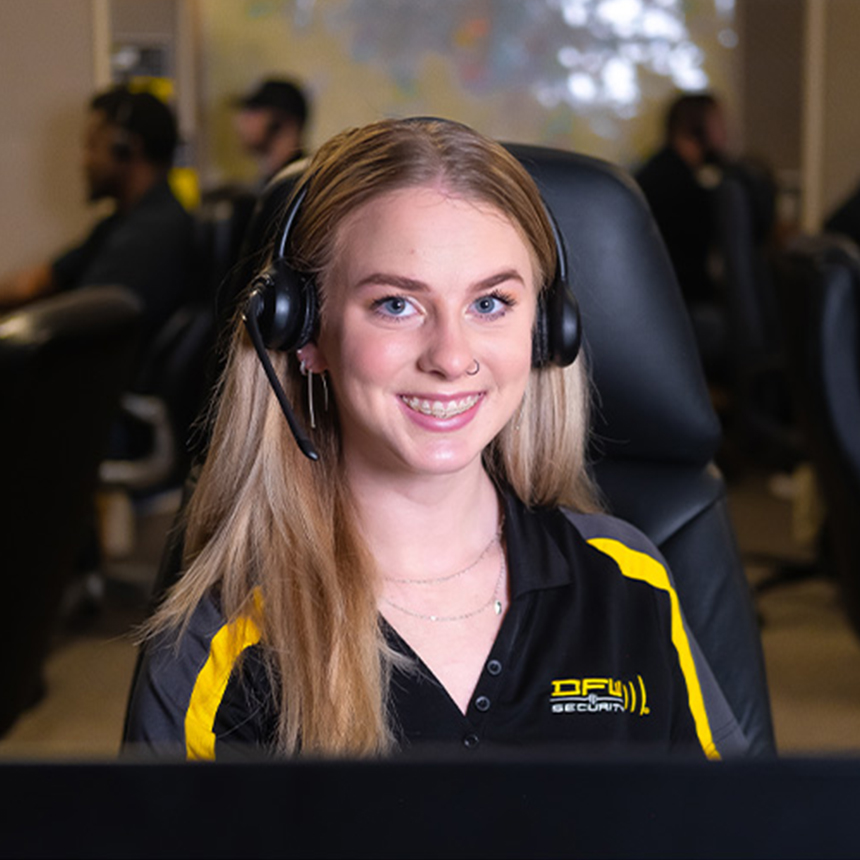 Smiling DFW Security inside sales representative at work