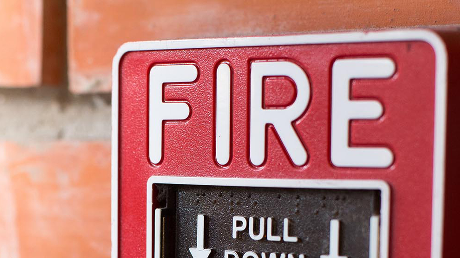 closeup of a fire alarm pull station
