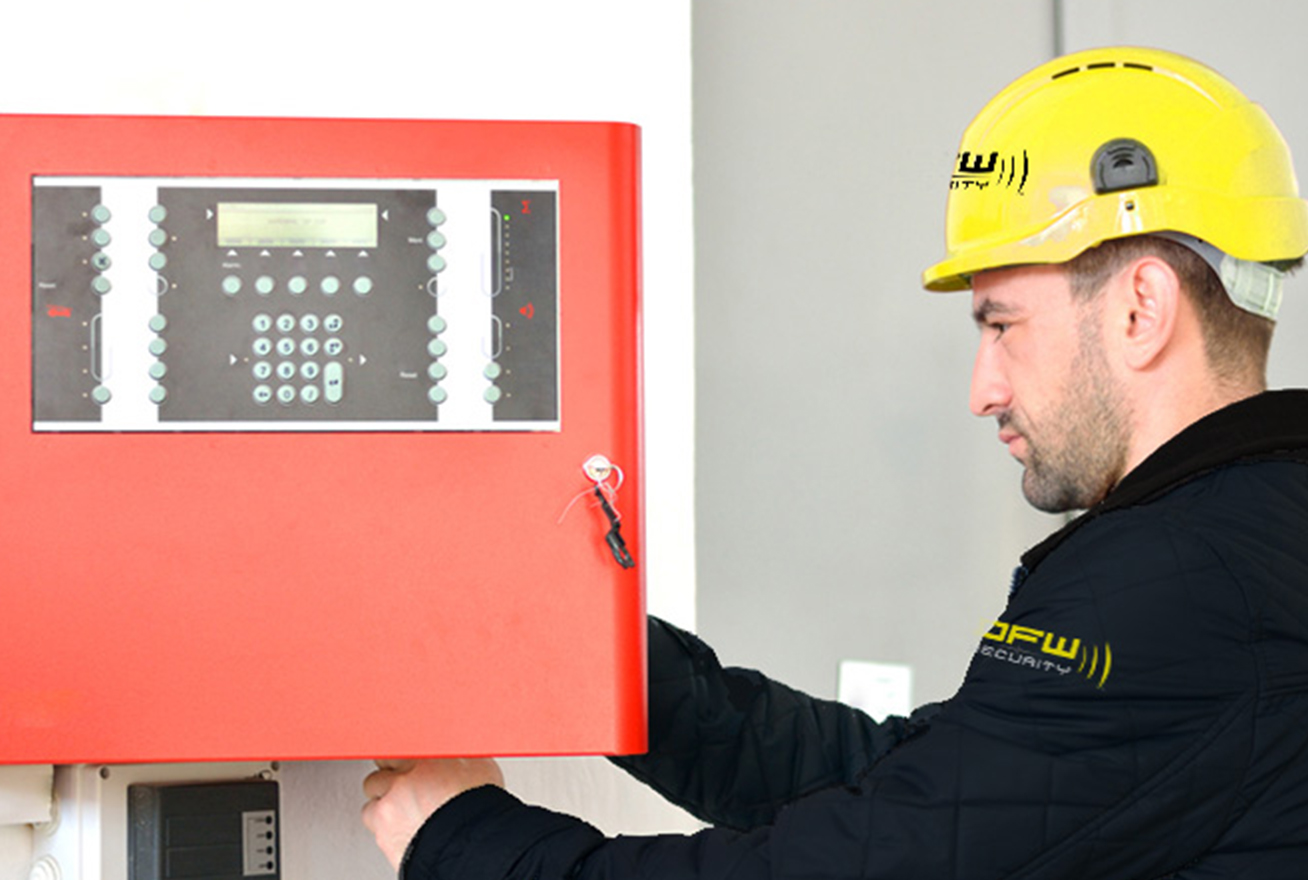 DFW Security fire technician working on fire alarm panel
