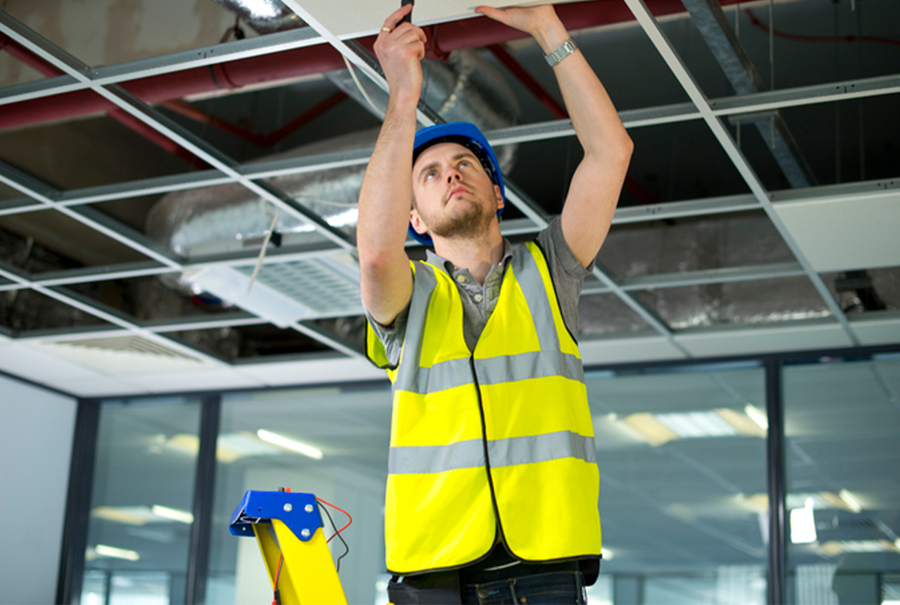 Technician installing fire alarm system