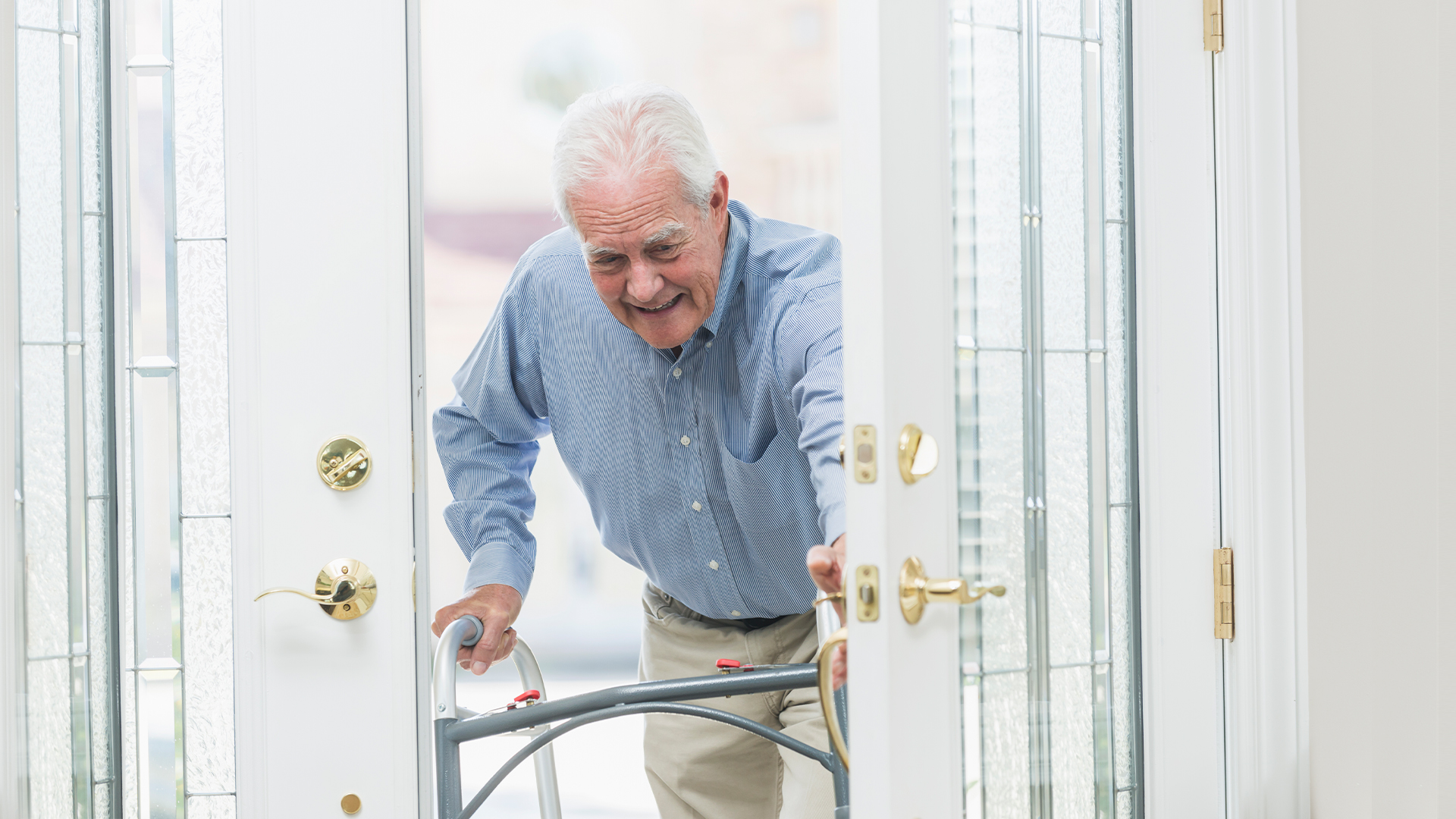 ElderlelefOlder man entering home with walker