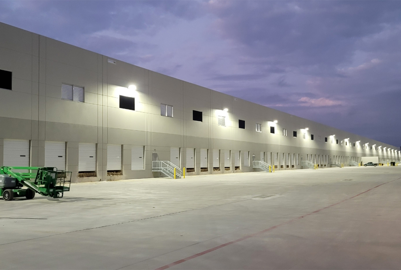 Outside of large warehouse at night protected by cameras