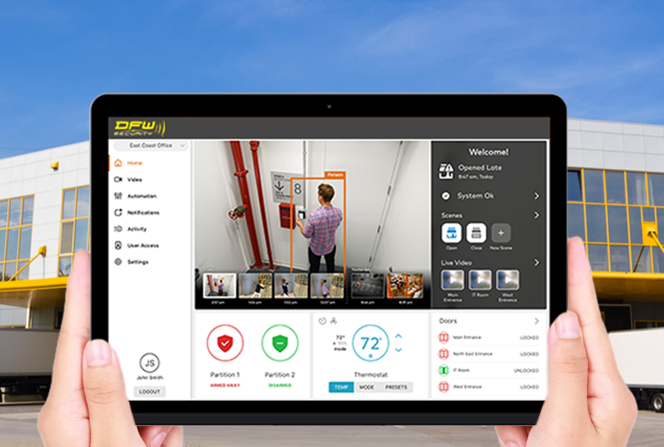 hands holding ipad outside commercial facility showing security app
