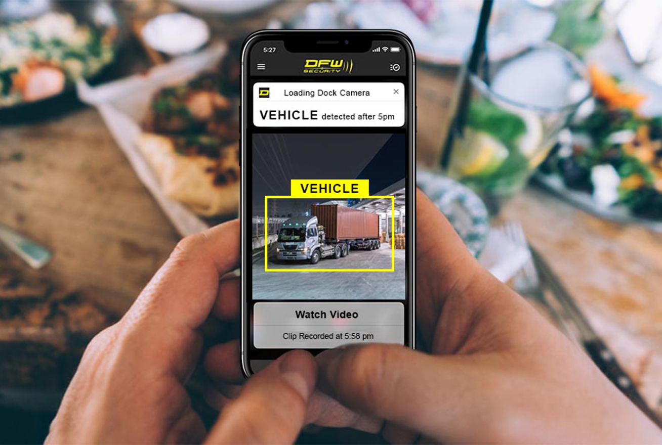 Looking at phone with video alert showing vehicle after hours