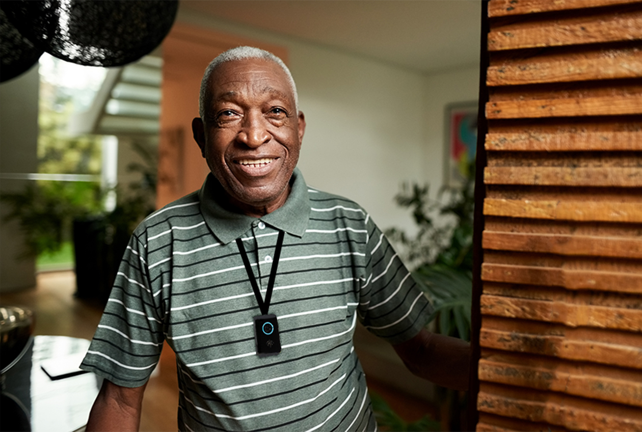 Elderly man wearing fall detector pendant