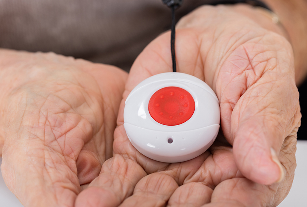 elderly woman holding medical panic button