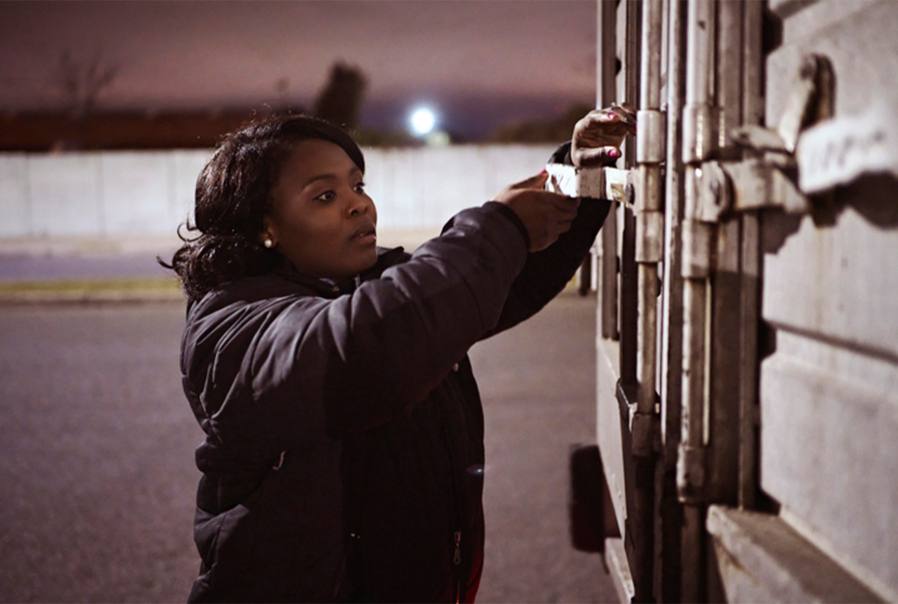 woman opening storage shed at night