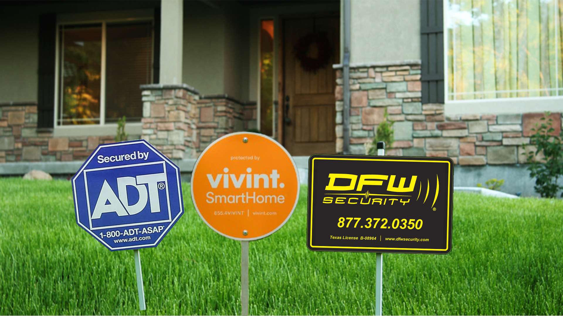 3 security yard signs in front of a house
