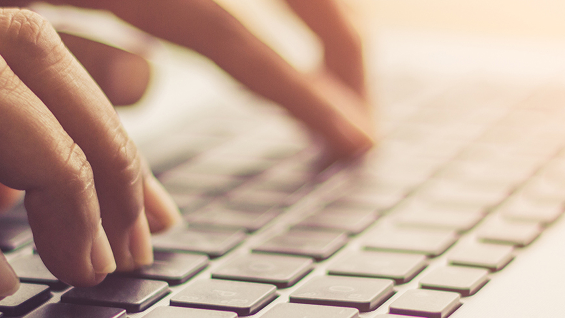 fingers typing on a keyboard
