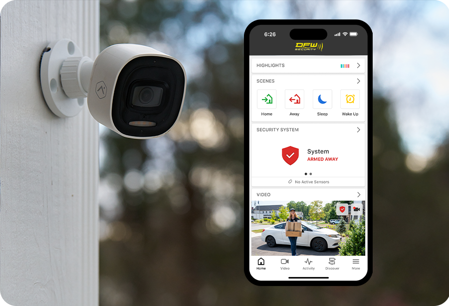 Outdoor camera next to a phone with the DFW Security app
