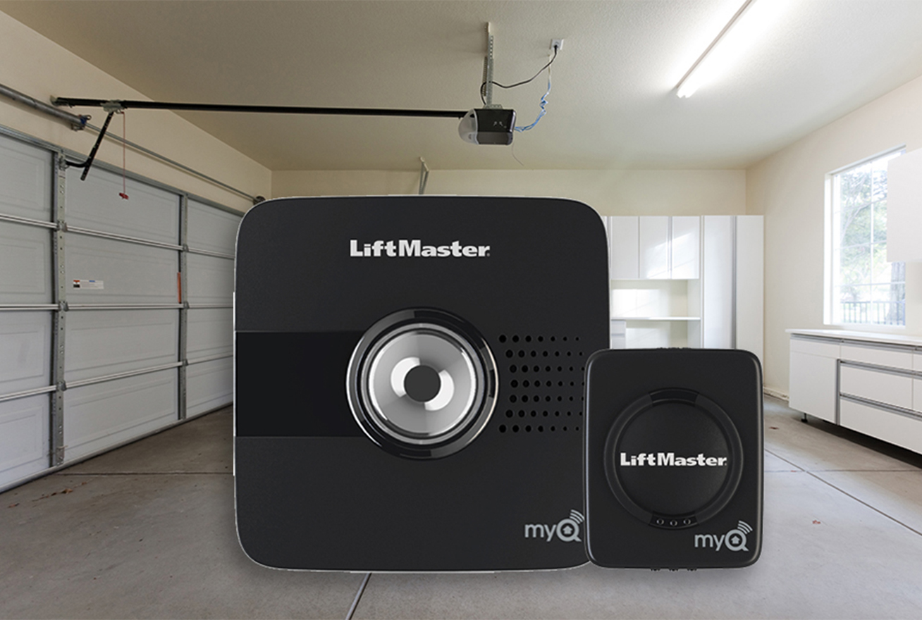 close up image of smart garage controller with garage in the background