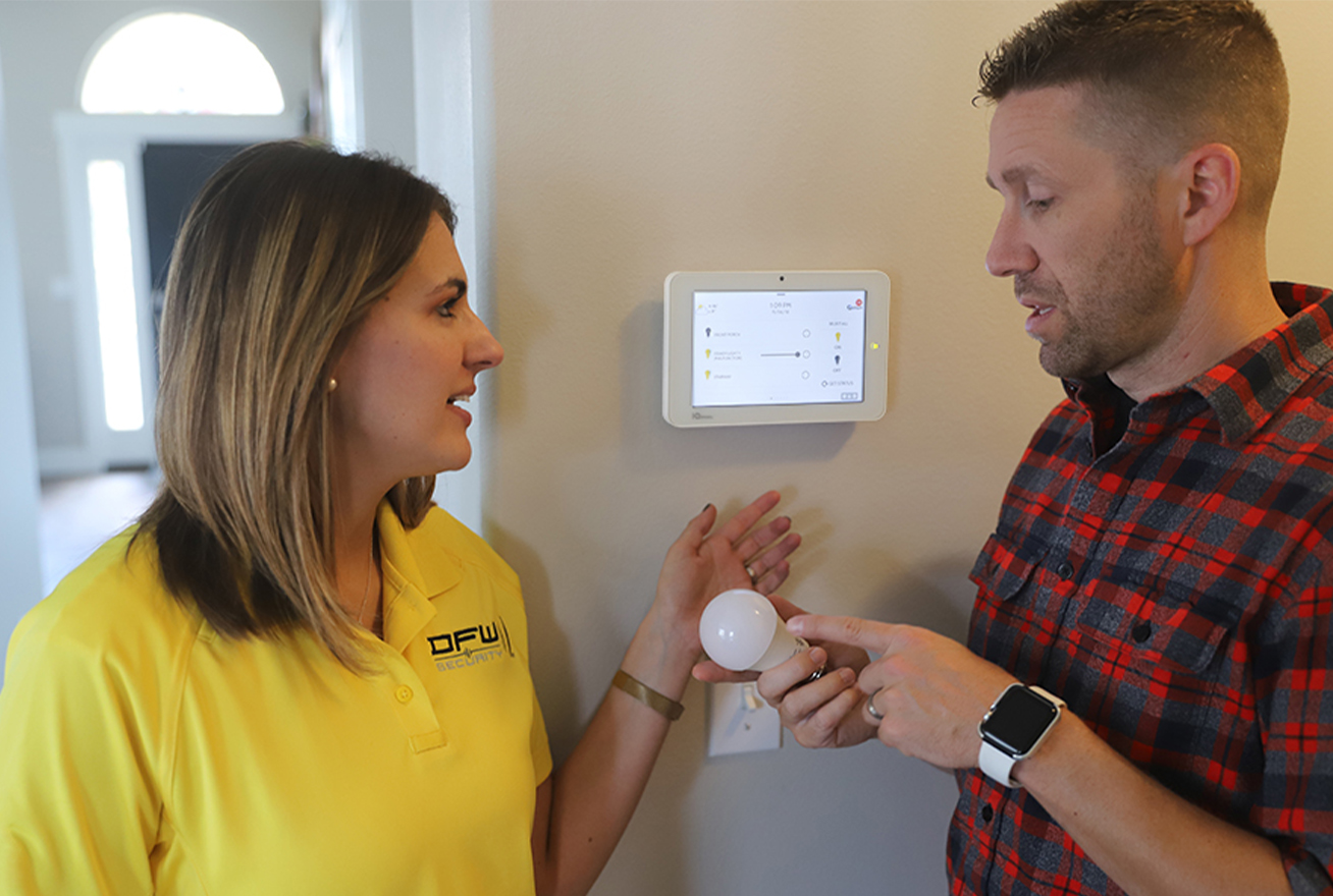 DFW Security employee talking to homeowner about smart lighting