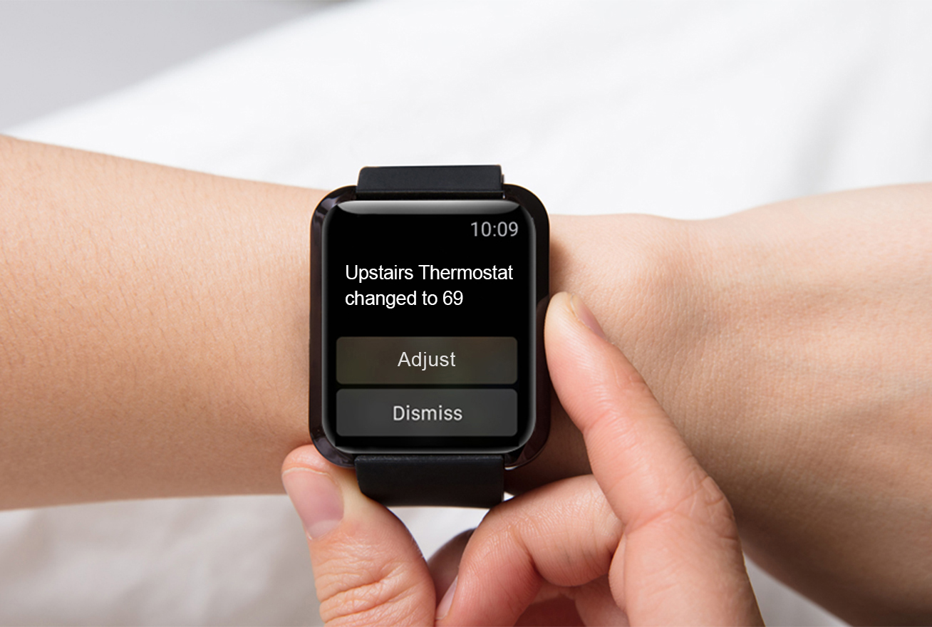 Person looking at thermostat alert on smart watch