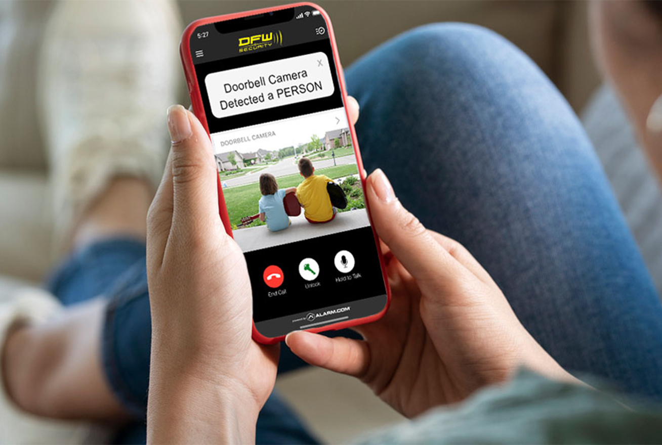 woman looking at doorbell camera footage on her phone