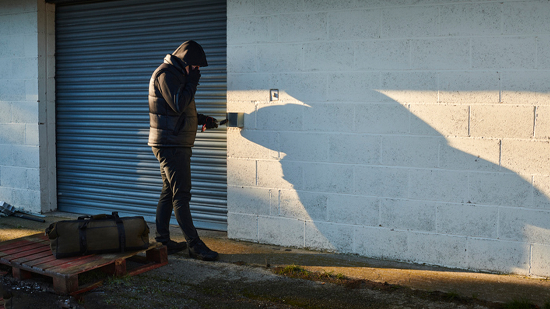 Man attempting to break into access control device
