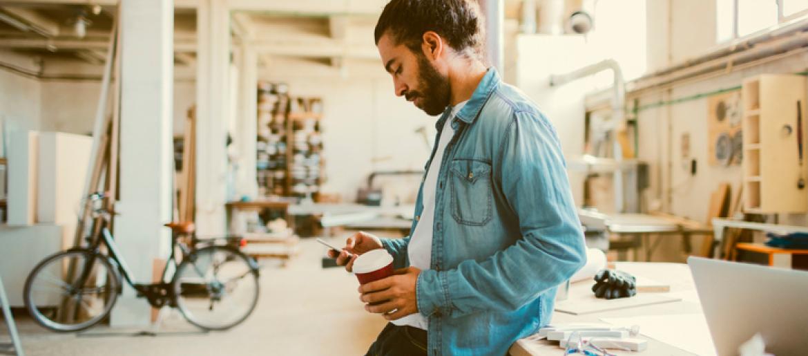 Business owner checking his phone