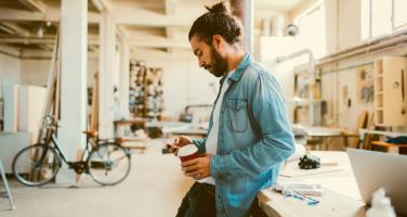 Business owner checking his phone